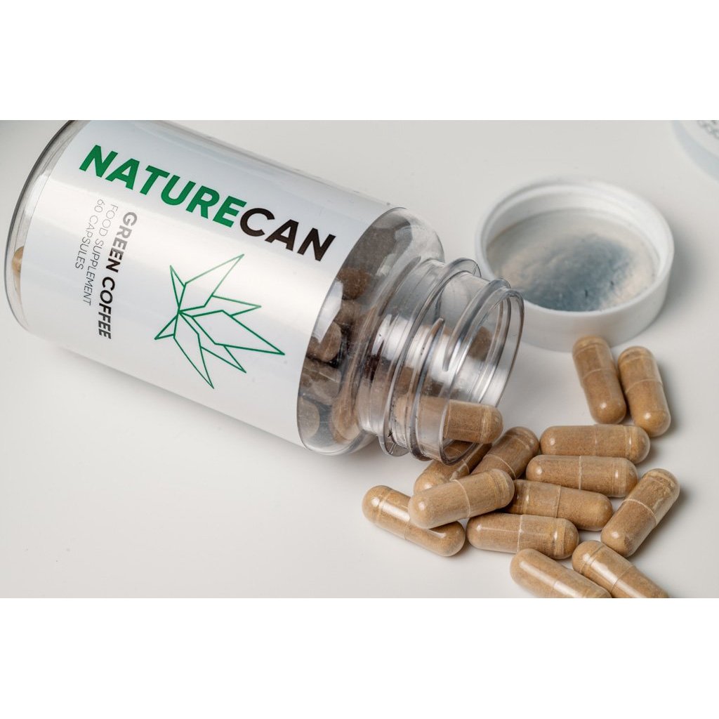 Green coffee extract capsules coming out of the bottle